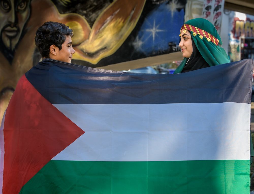 Protesters wave large Palestinian flags during a demonstration in support of Palestine.