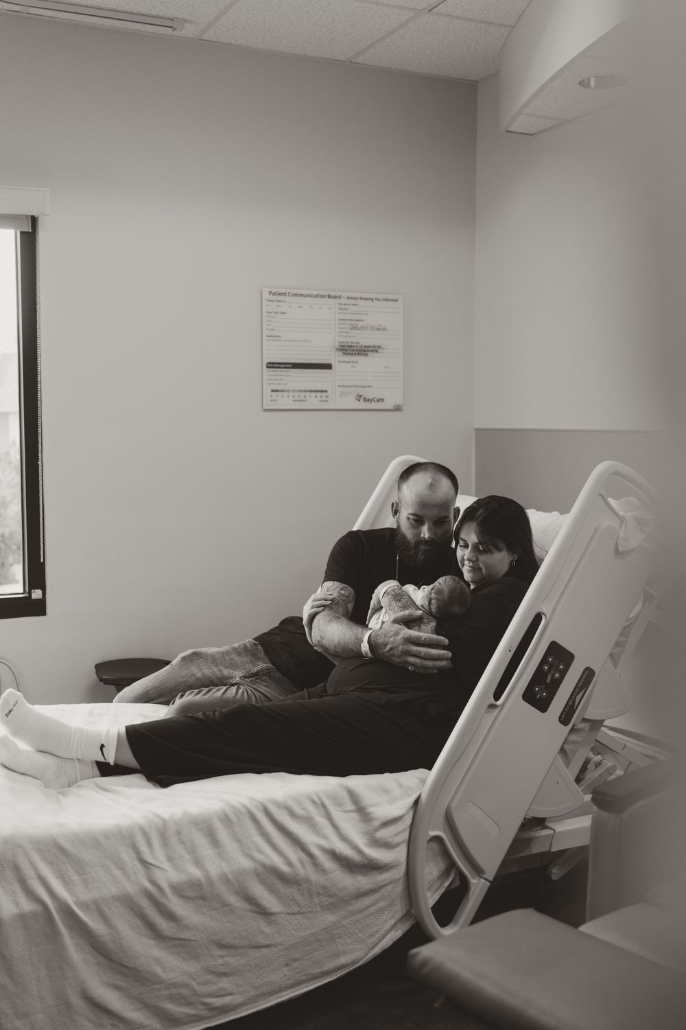 Hospital bed with medical equipment in a bright clinical room.