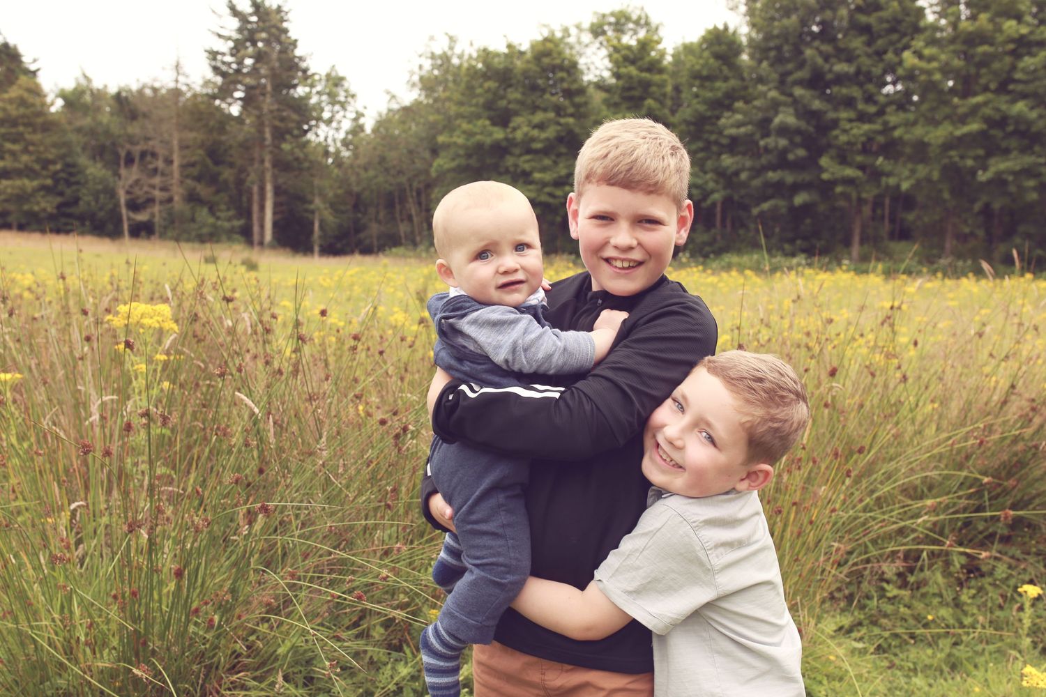 three children playing and exploring in the serene environment of Dunnottar Woods, capturing the joy and wonder of childhood