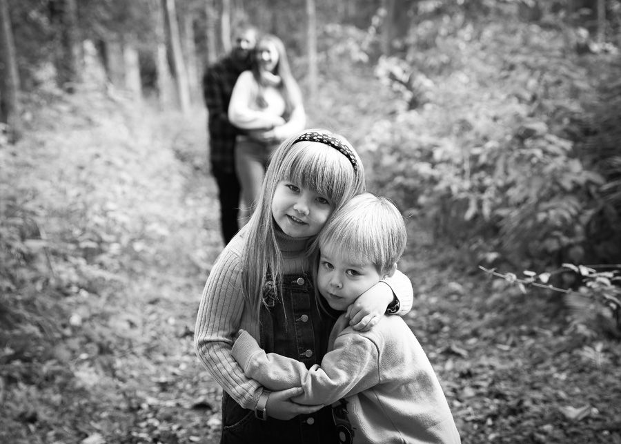 two children playing and exploring in the serene environment of Dunnottar Woods, capturing the joy and wonder of childhood