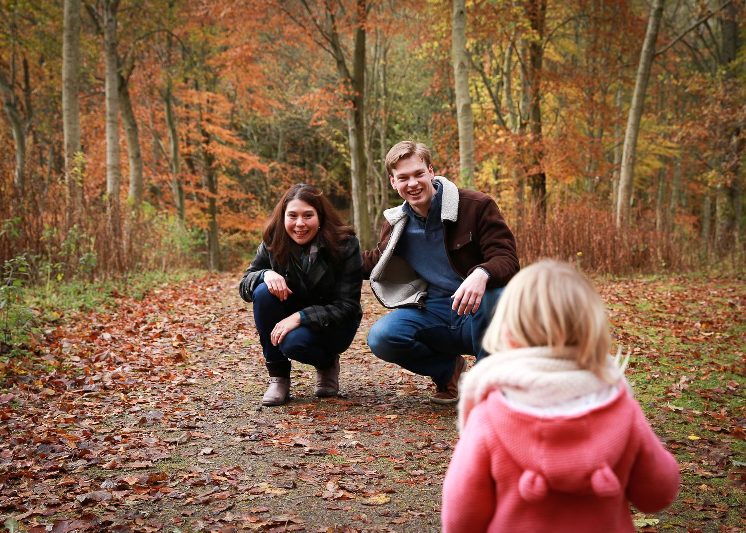 A joyful family enjoying a moment together in the tranquil surroundings of Dunnottar Woods, capturing the beauty of nature and connection