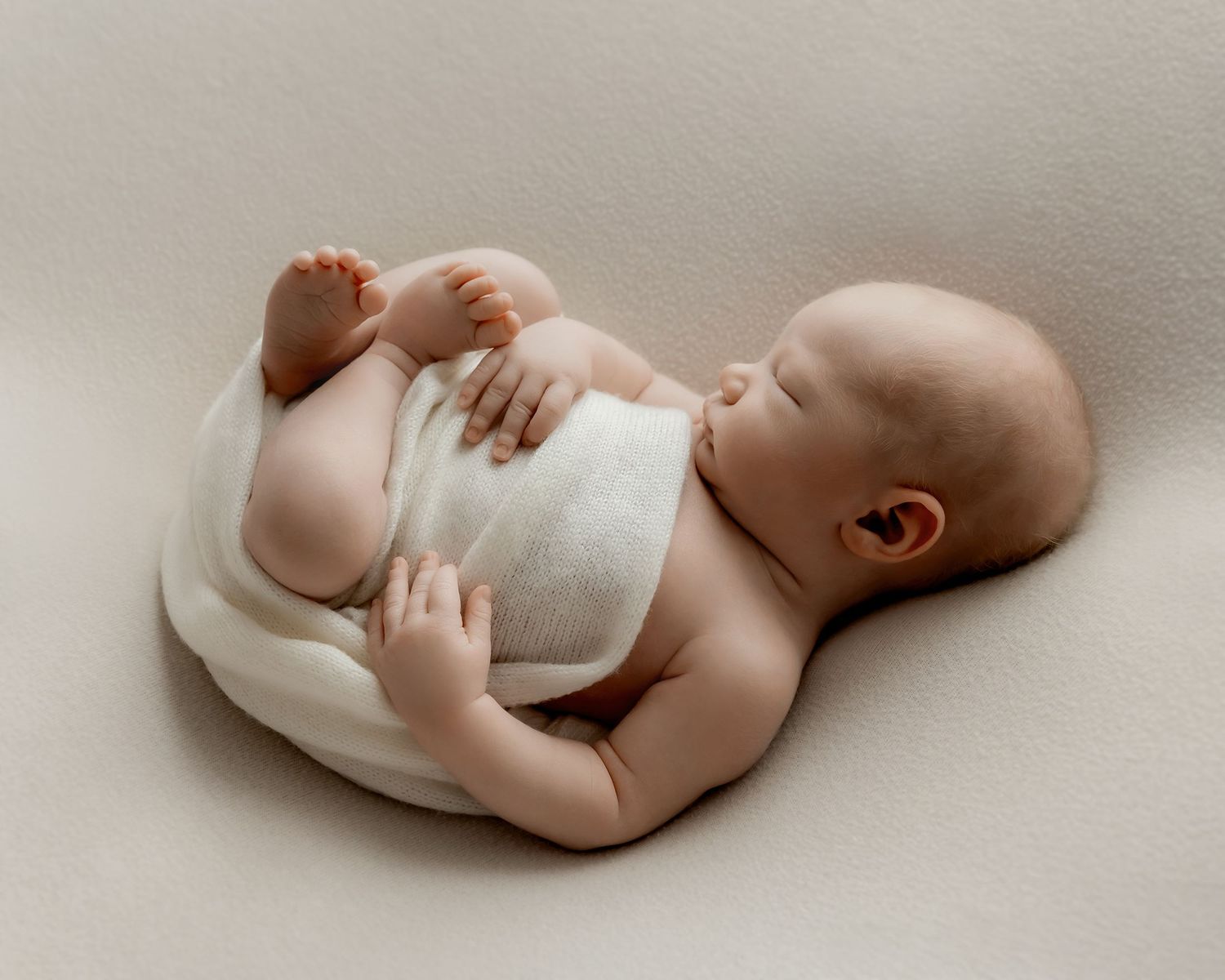 Newborn baby photographed using curated newborn styling