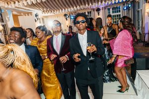 Elegantly dressed guests dancing and socializing at a glamorous evening party event.