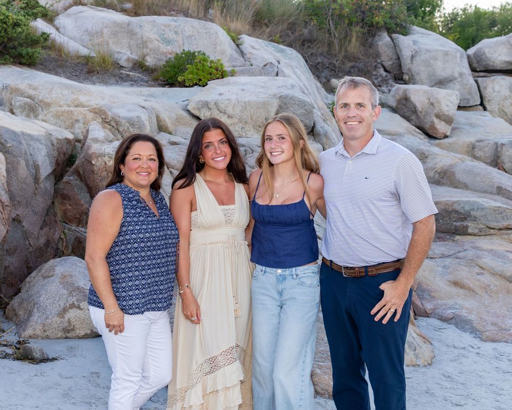 Family poses together on Wingaersheek Beach Gloucester, MA. Beach family photos available on Cape Cod- Eastham, Orleans, Chatham, Nantucket.