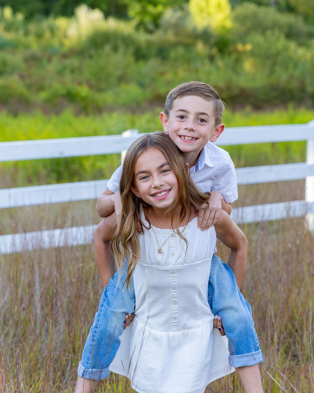 Family photo of siblings at Wolbach Farm in Sudbury, MA during the summer for family photography session.  Weston, Concord, Wayland.
