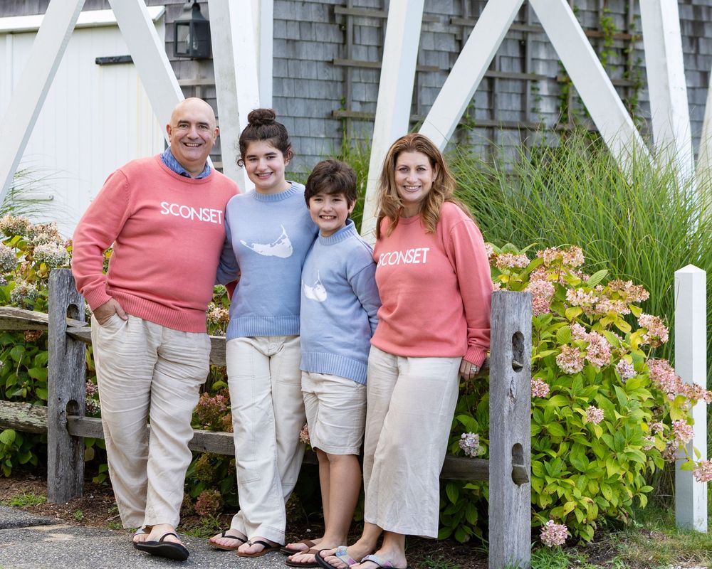 Family poses together in town Sconset Nantucket, MA. Beach family photos available for Cape Cod- Eastham, Orleans, Chatham, Nantucket.