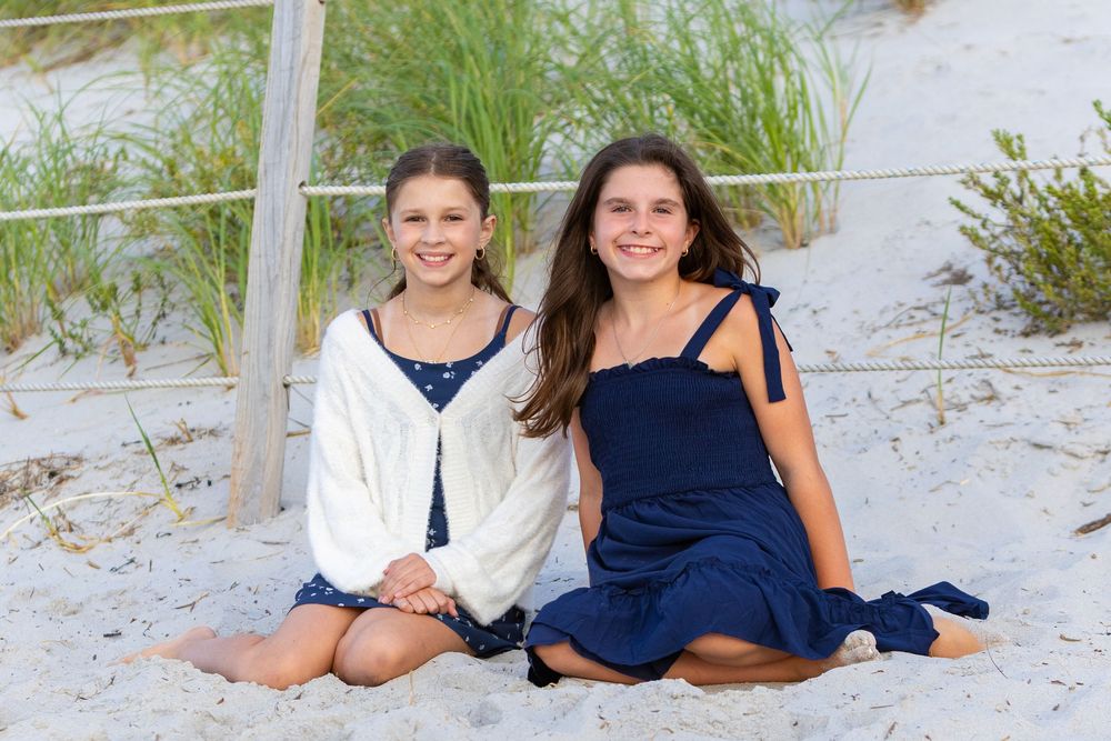 A family poses together on Mayflower Beach in Dennis. Beach family photos available for Cape Cod- Eastham, Orleans, Chatham, Nantucket.