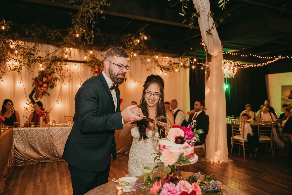 Documentary editorial wedding photography in Iowa by My Muse Weddings shows a cake cutting moment during a wedding at The Conservatory, Iowa