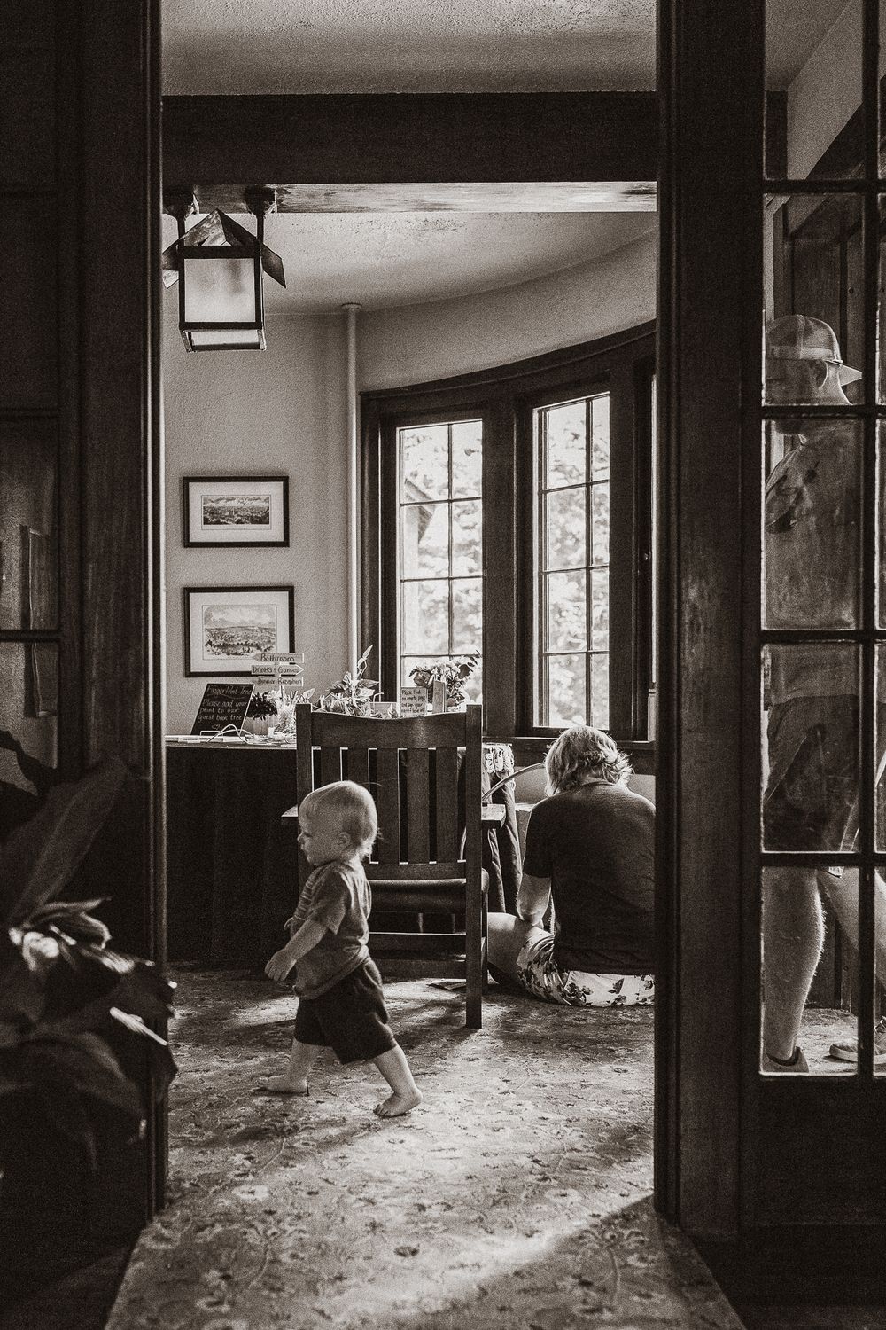 Documentary editorial wedding photography in Iowa by My Muse Weddings shows a candid moment of a child while his mother preps for a wedding.