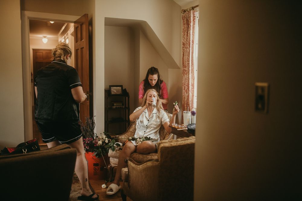 Documentary editorial wedding photography in Iowa by My Muse Weddings shows Dubuque, Ia bride casually hanging out before ceremony.