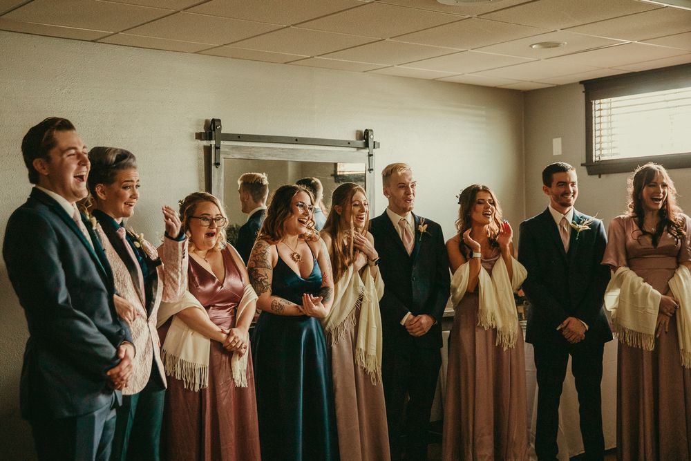 Documentary editorial wedding photography in Iowa by My Muse Weddings shows party emotional after seeing the bride for the first time.