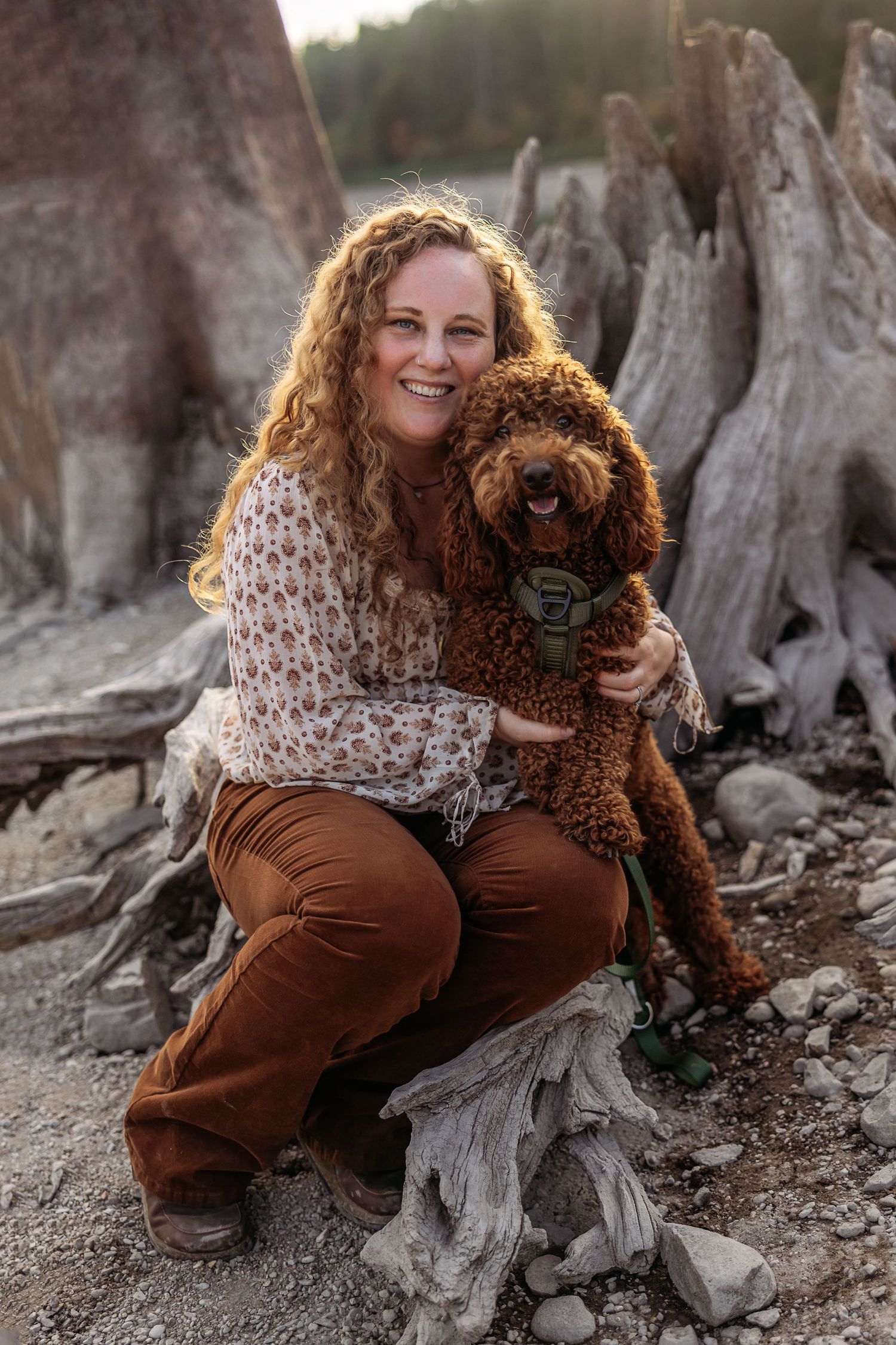 Tori, the owner of Pine + Vow, with brown doodle dog.