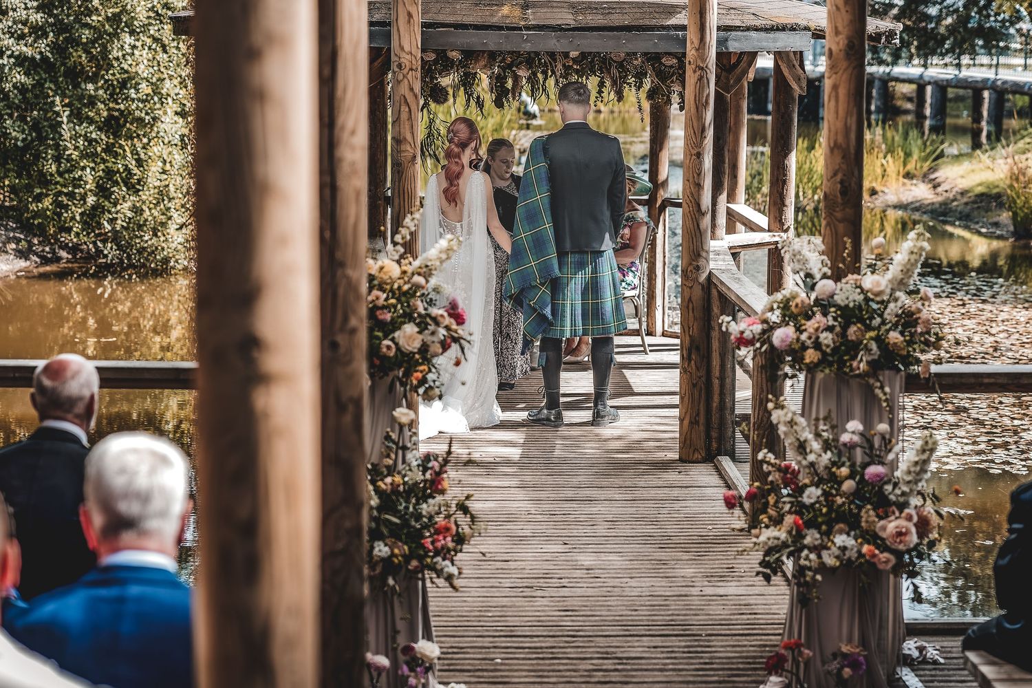 Outdoor wedding ceremony atmosphere at countryside venue.