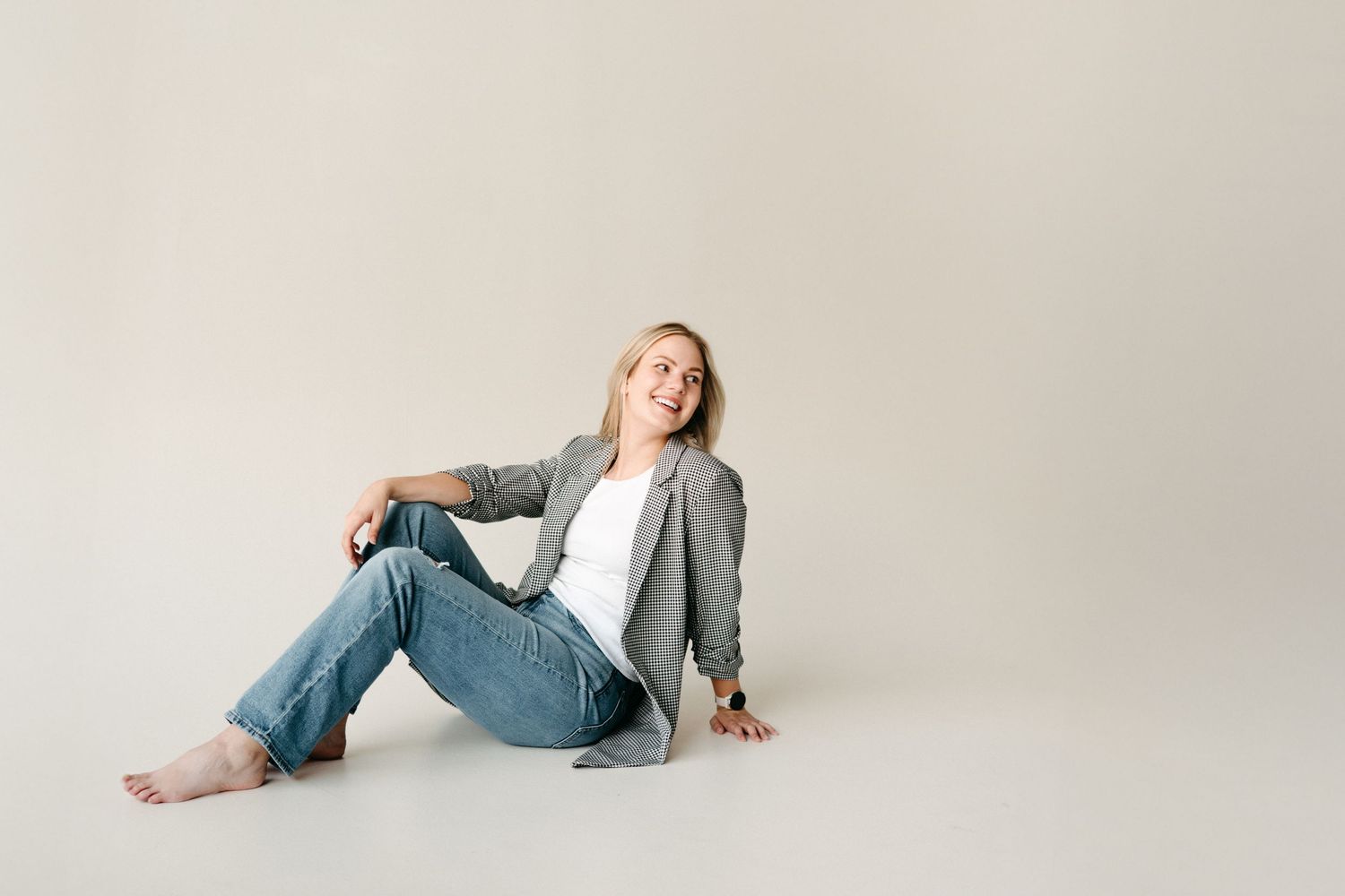 Creative business owner laughing during a relaxed studio branding photoshoot.