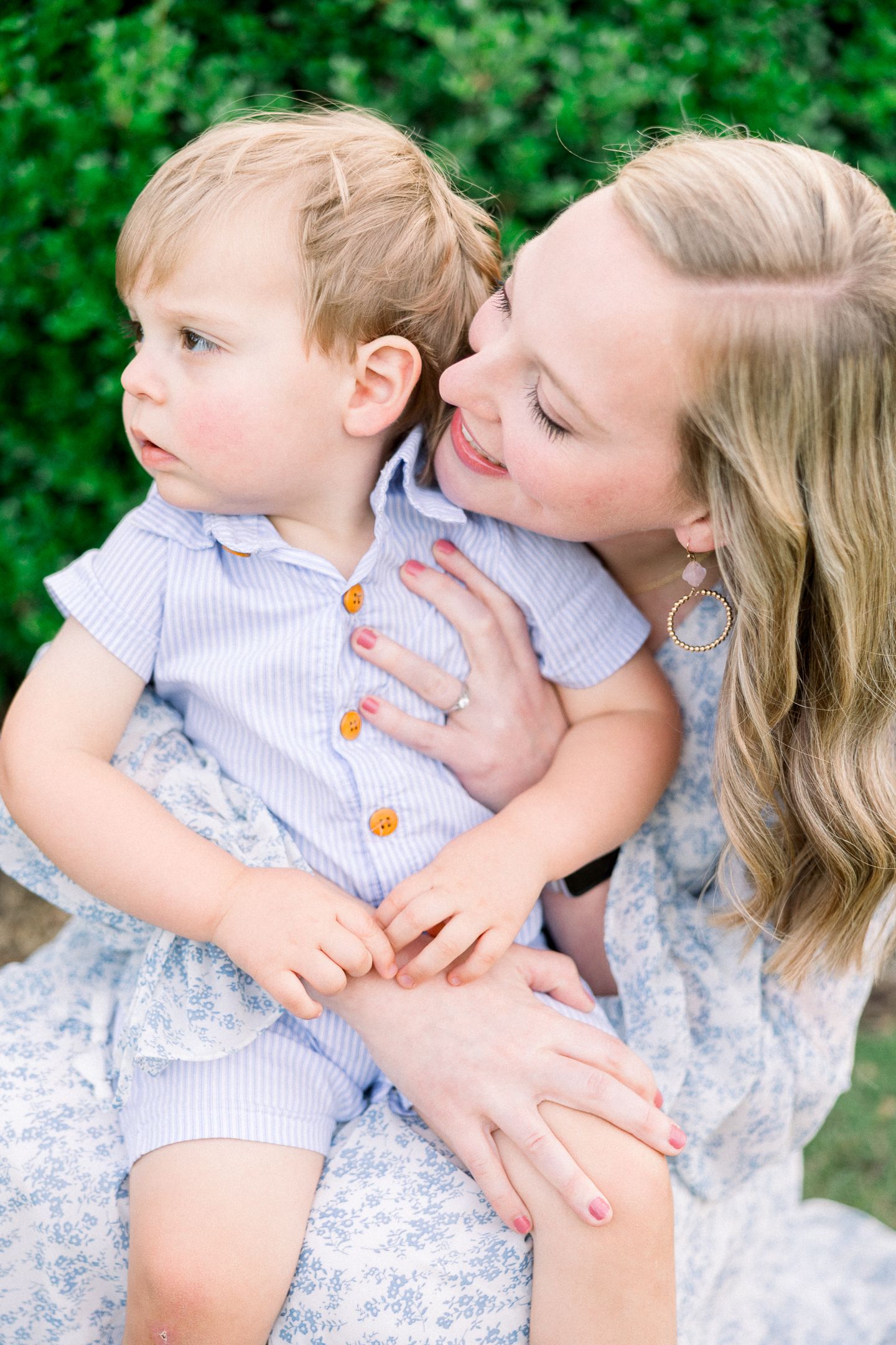 Mother holding toddler during relaxed outdoor family photos in Augusta GA