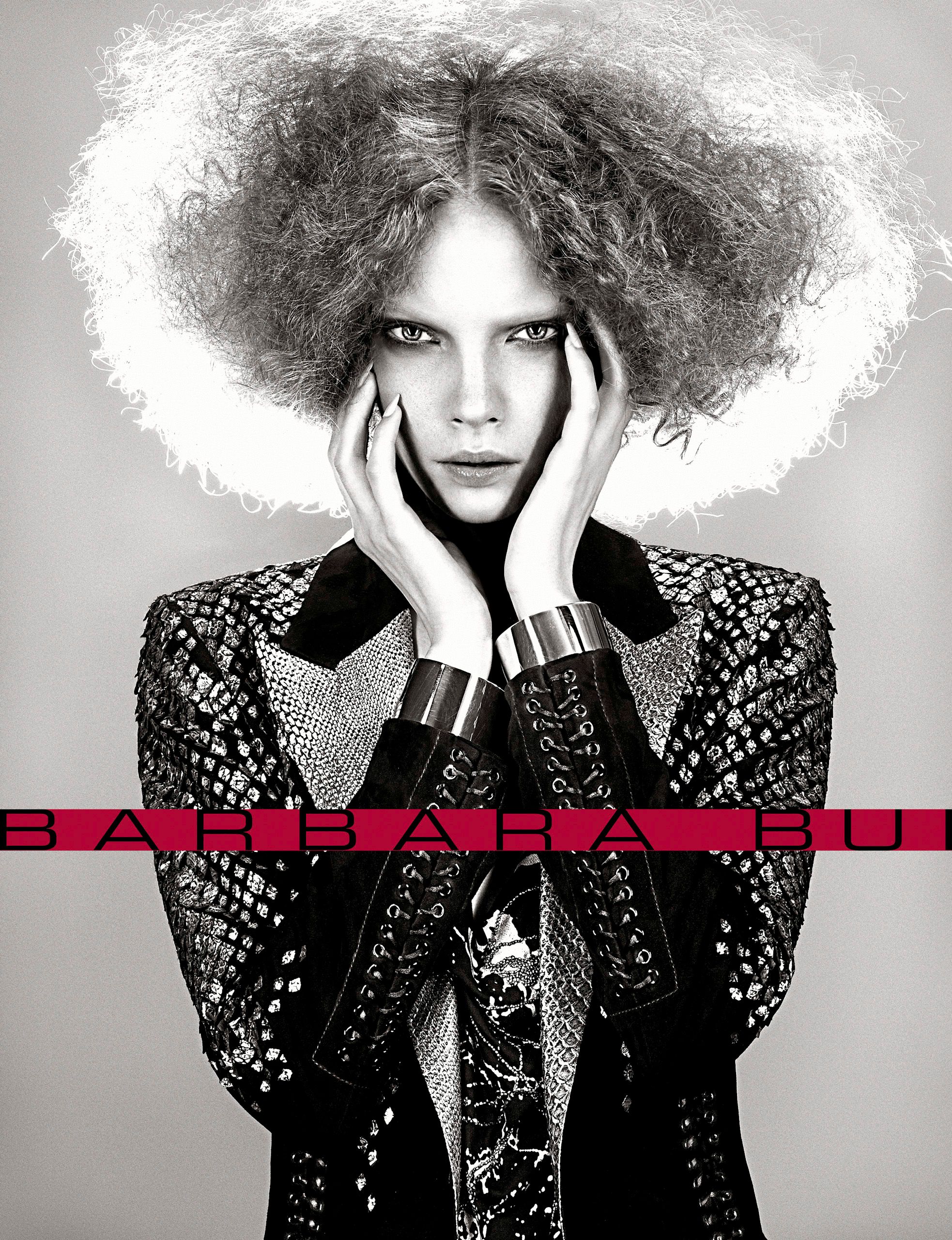 Barbara Bui fashion campaign featuring model in embellished jacket with voluminous curly hair in black and white.