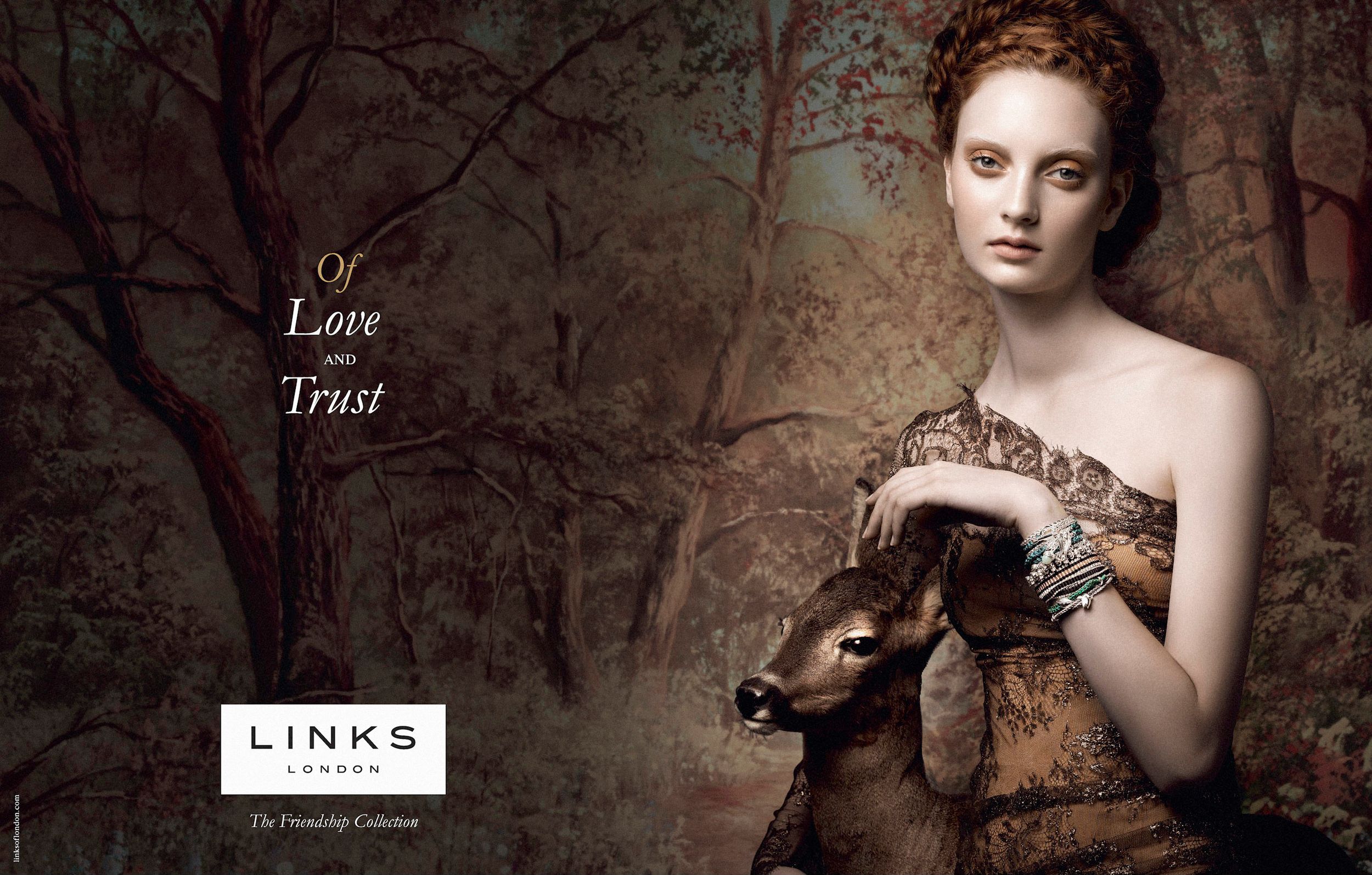 Links of London jewelry ad featuring a redhead model in forest setting holding a deer, with Of Love and Trust text.