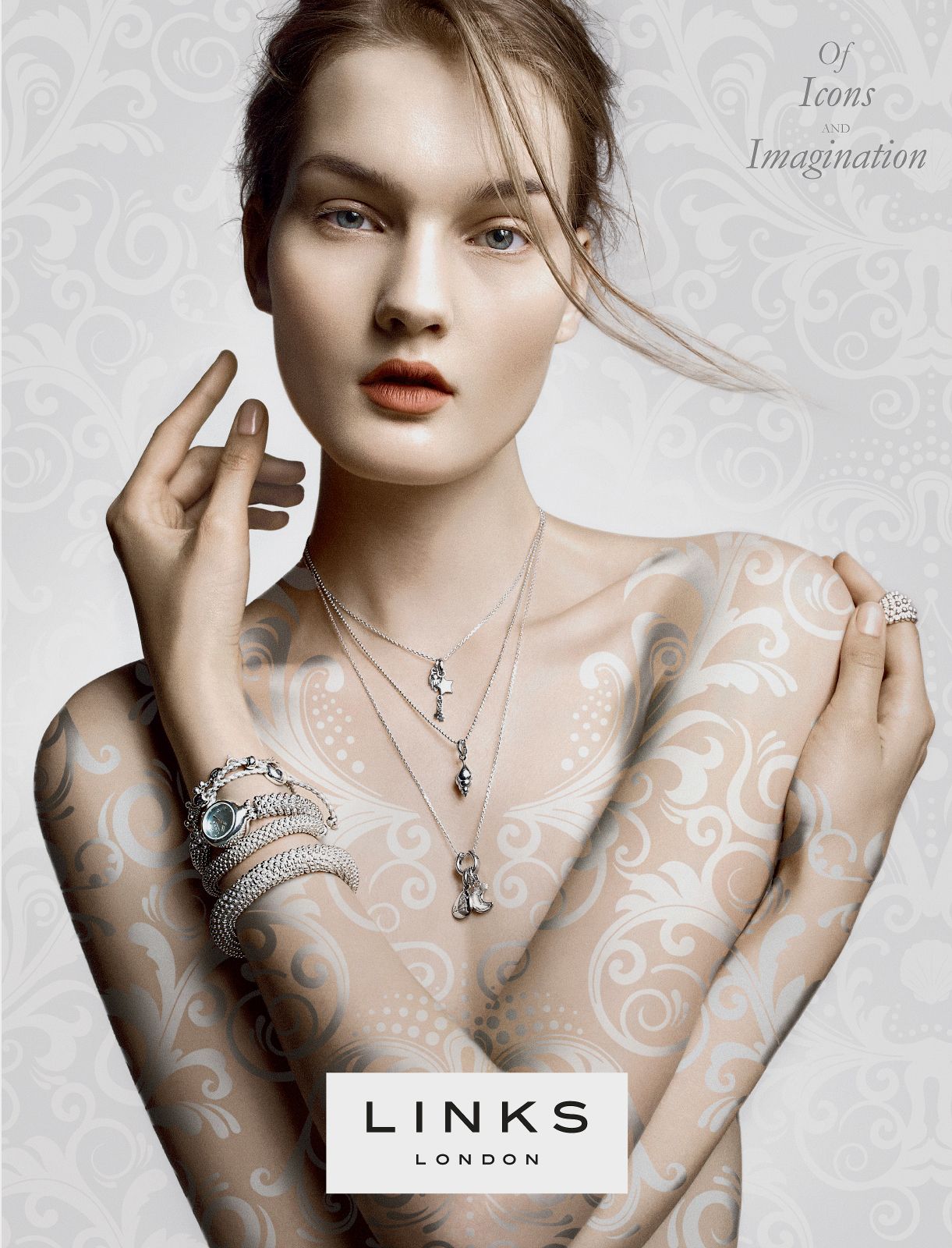Links of London jewelry ad featuring a model adorned with silver necklaces, bracelets, and rings with floral body art.