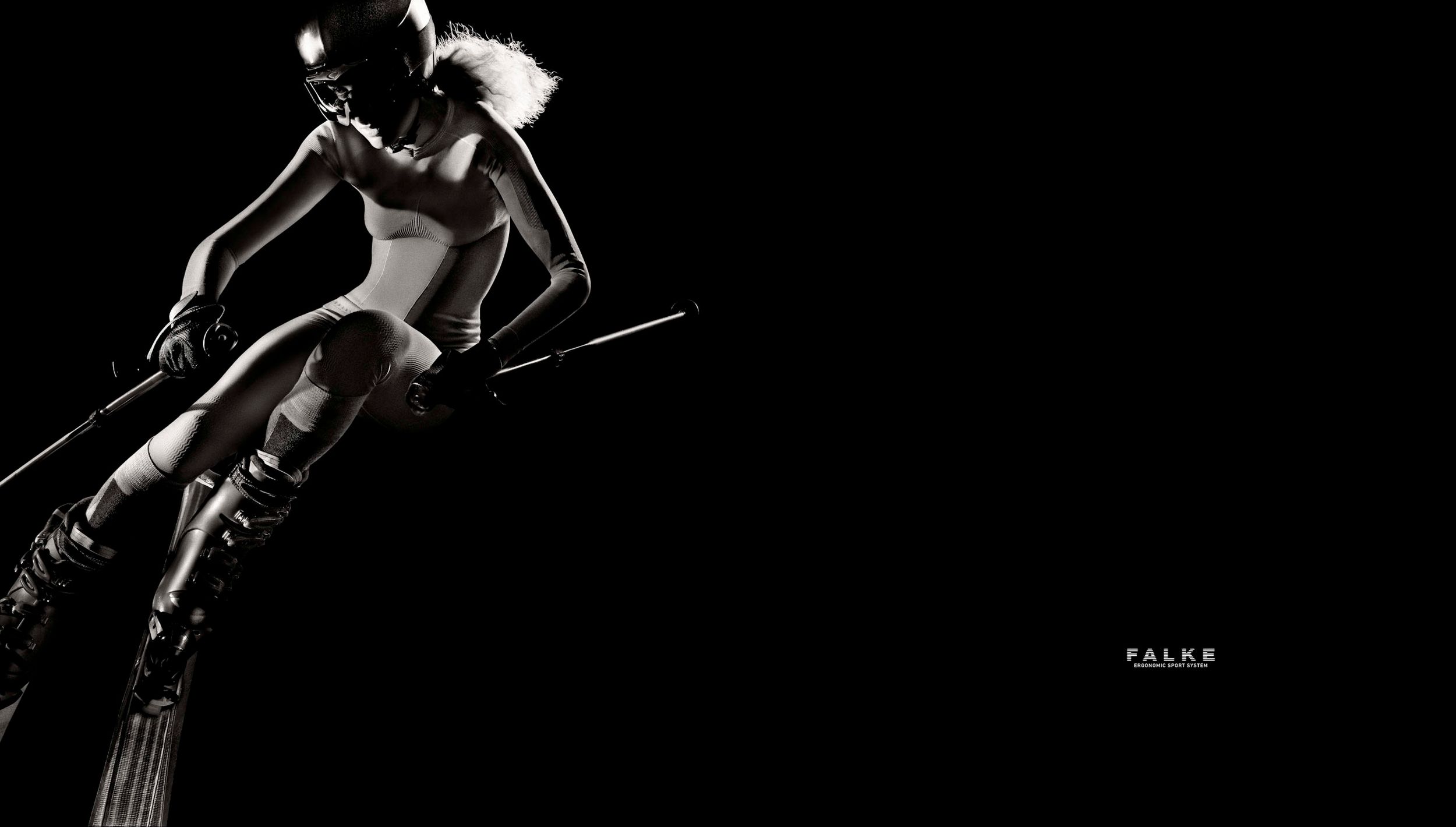Female skier in action on slopes wearing sportswear in a dramatic black and white Falke ad.