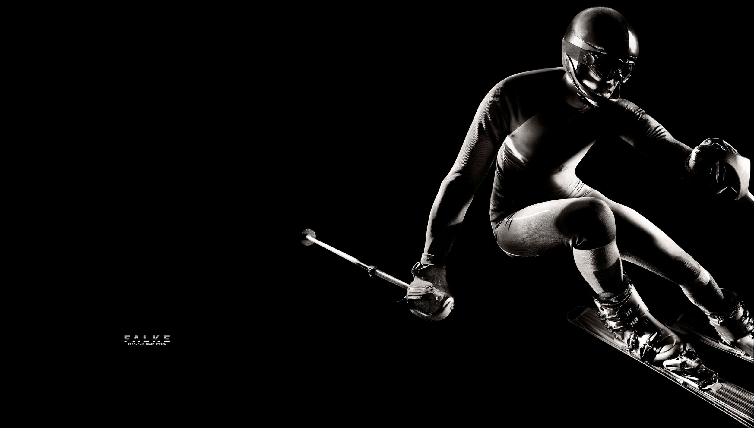 Dynamic black and white image of a football player in full gear performing an aggressive skiing pose.