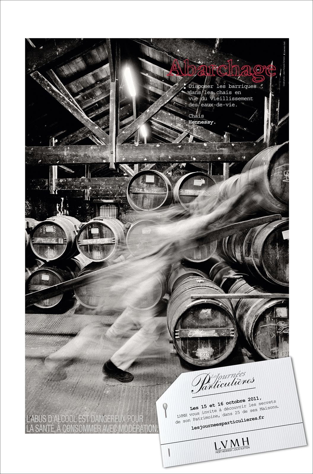 LVHM Journées Particuliers 2011 poster featuring a blurred figure moving past oak barrels in a dimly lit cellar.