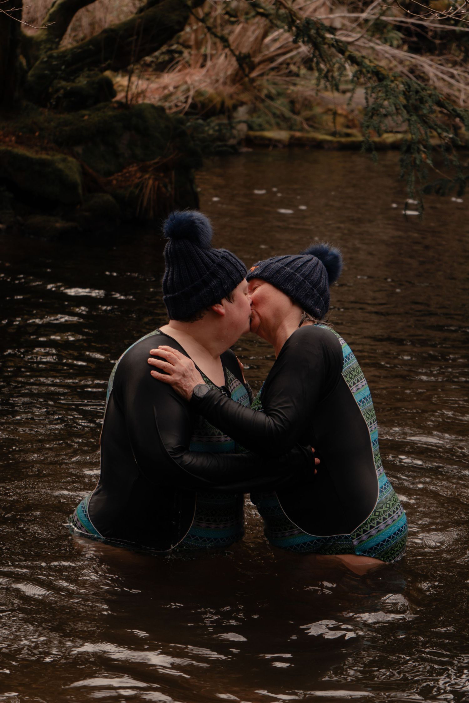 couple kiss during wild swim in Scottish Borders captured by Scottish intimate wedding and elopement photographer