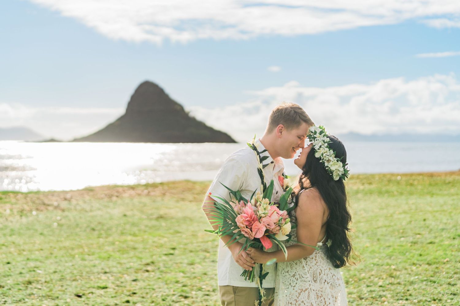 Romantic wedding portrait with Chinaman's Hat island in the background at Kualoa Ranch.