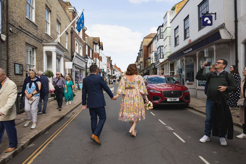 Wedding couple walking to Rye Town Hall