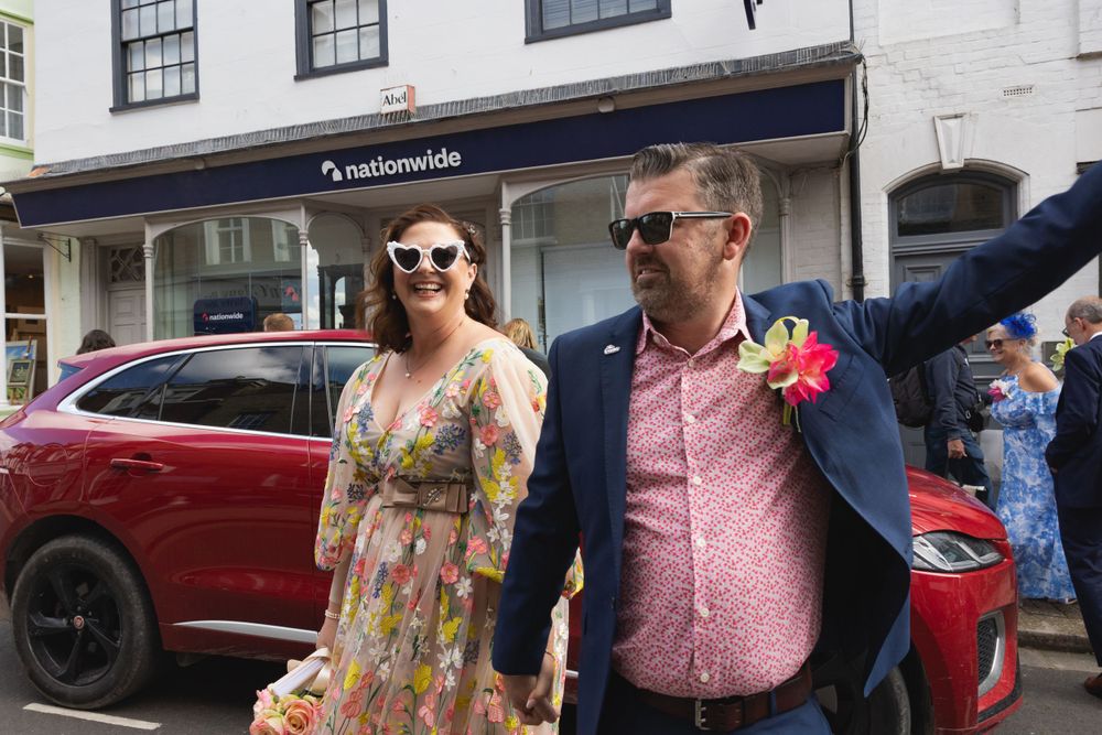 Wedding couple walk to Rye Town Hall