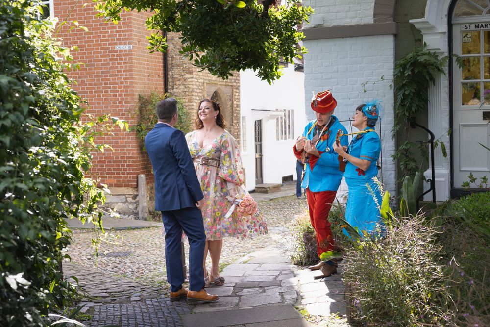 Wedding couple serenaded by wandering minstrels in Rye