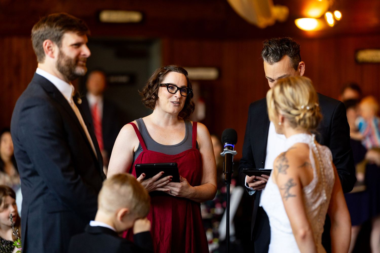 Wedding celebration in rustic indoor venue with guests mingling.