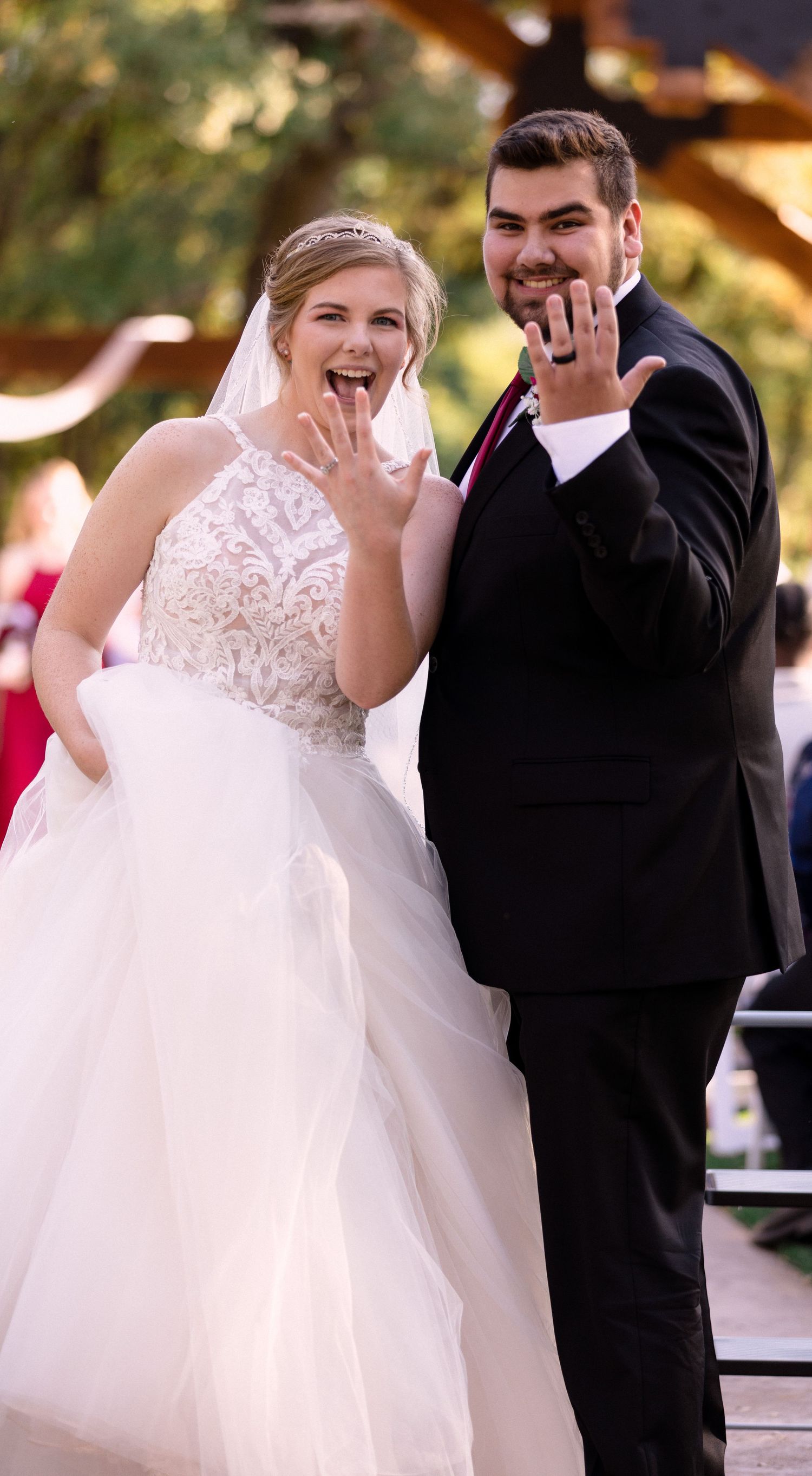 Married couple showing off their wedding rings.