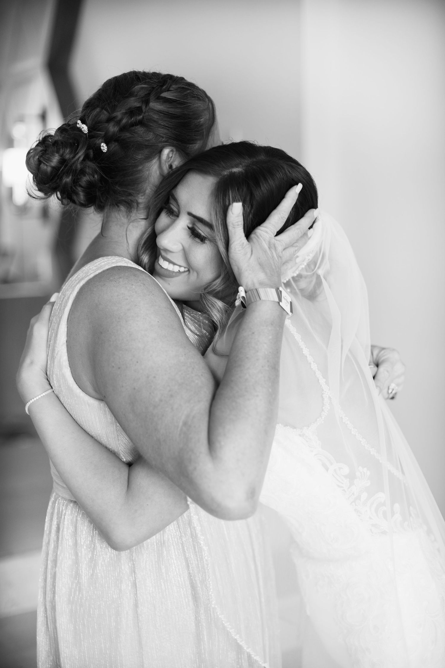 Bride hugging her mother.