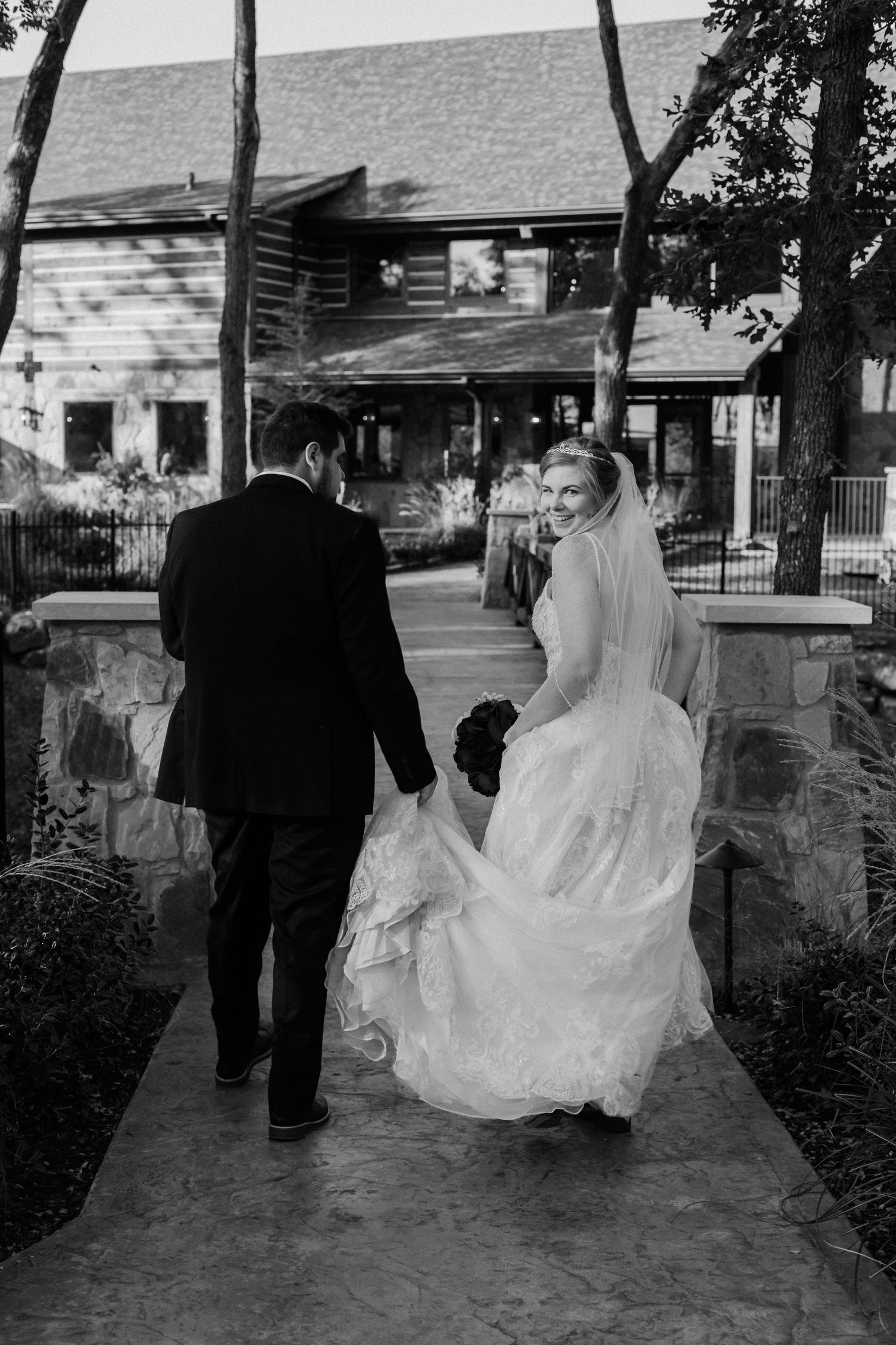 Bride looking back while walking with the groom.