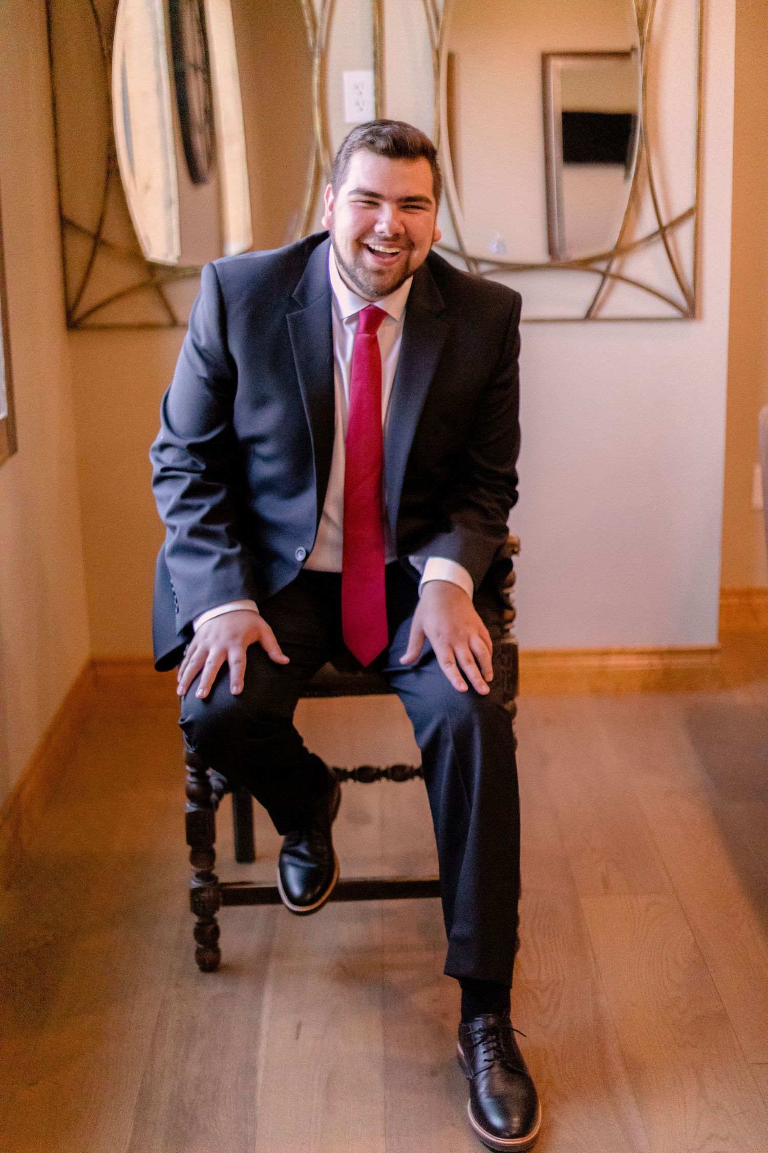 Groom laughing on his chair.