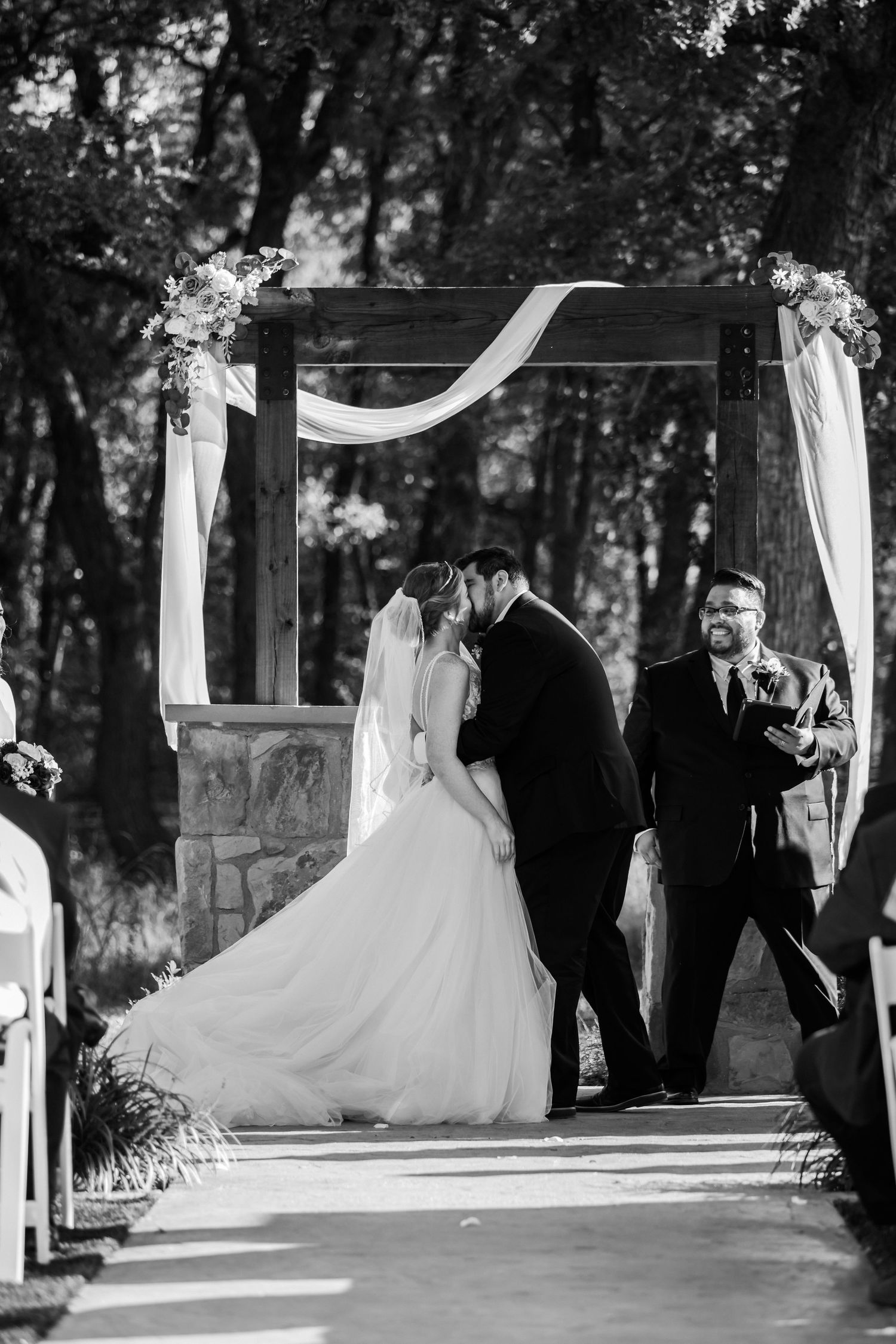 Married couple kissing at the alter.