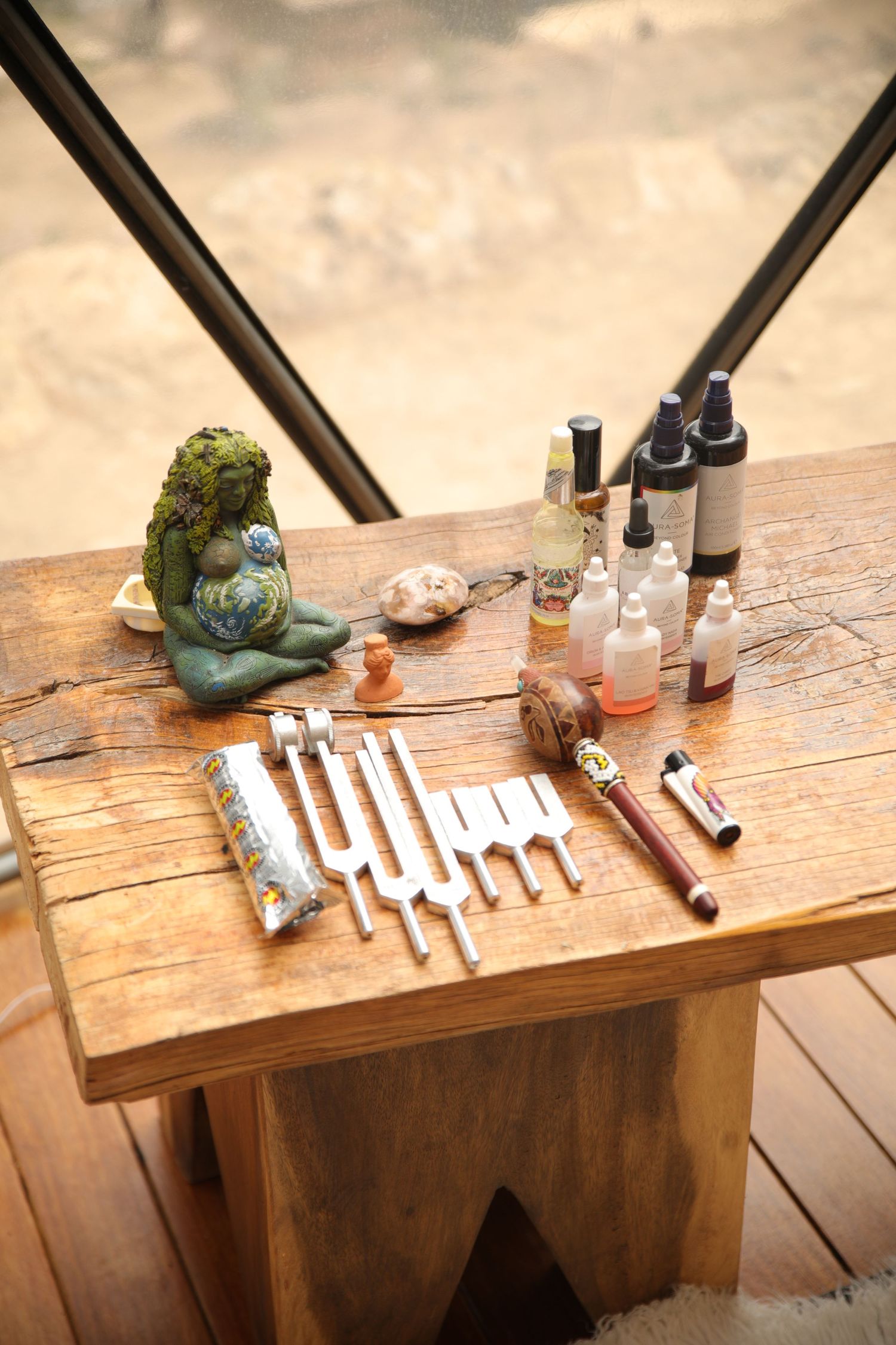 Collection of small bottles and decorative items arranged on a wooden shelf.