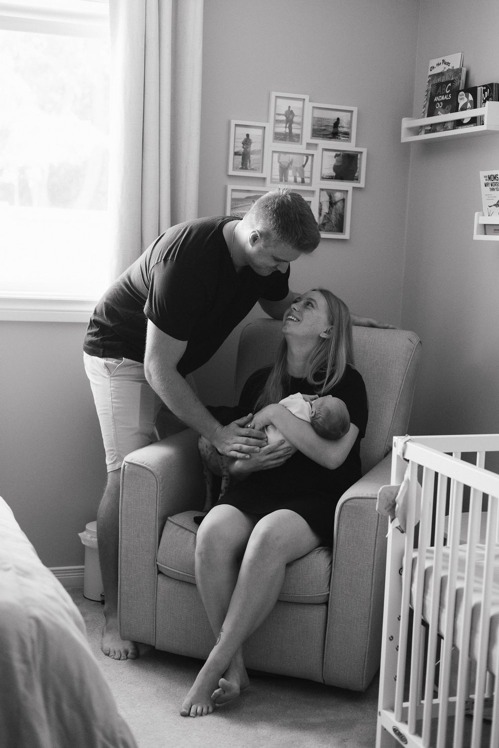 A series of black and white photos showing tender moments in a nursery room with a gray armchair.