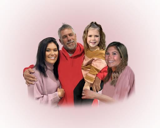 Family group portrait against pink background with casual attire.