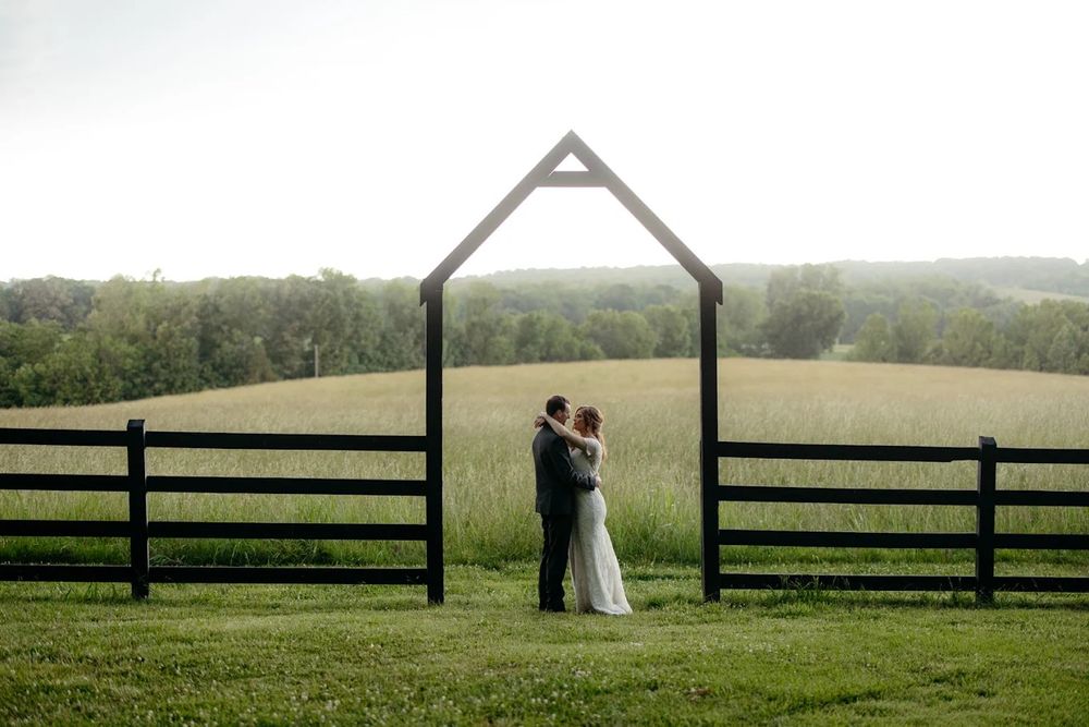 A panoramic wedding photo series showing a couple posing in a serene green field with wooden fences and rolling hills.