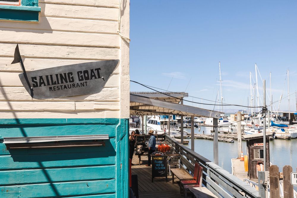 A collage of marina views showing boats docked at a waterfront with teal-colored accents and restaurant signage.