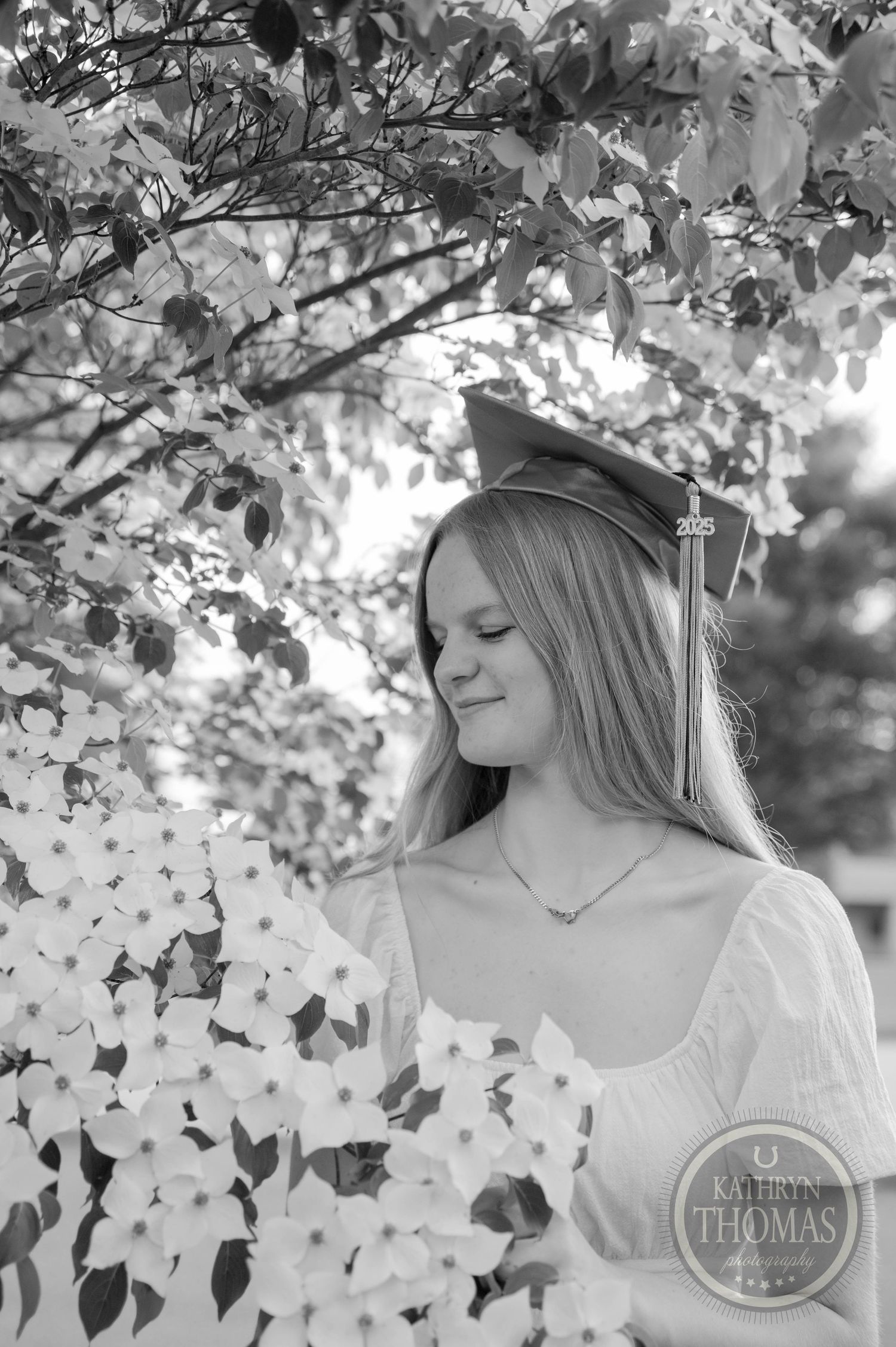Black and white portrait series showing soft natural moments under autumn tree branches with delicate lighting and leaves.