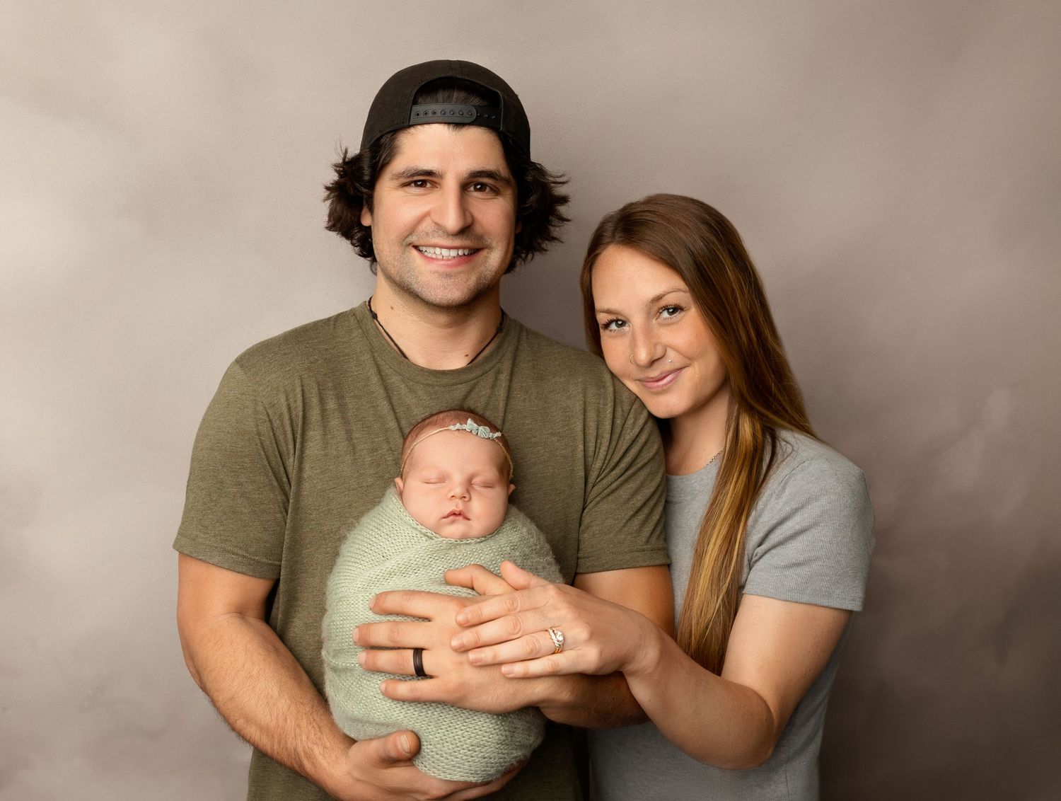 Mom and dad with baby at a newborn session at Stephanie Ann Photography in New Hampshire