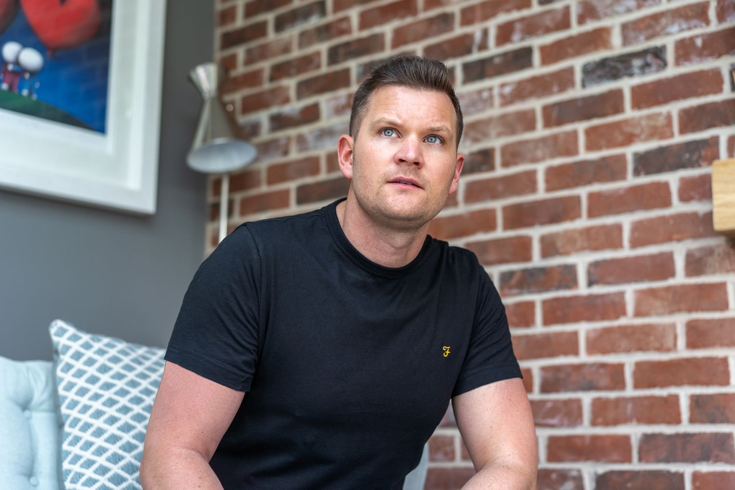 London based Founder sits for a photo during a personal branding photoshoot to promote him and his business.