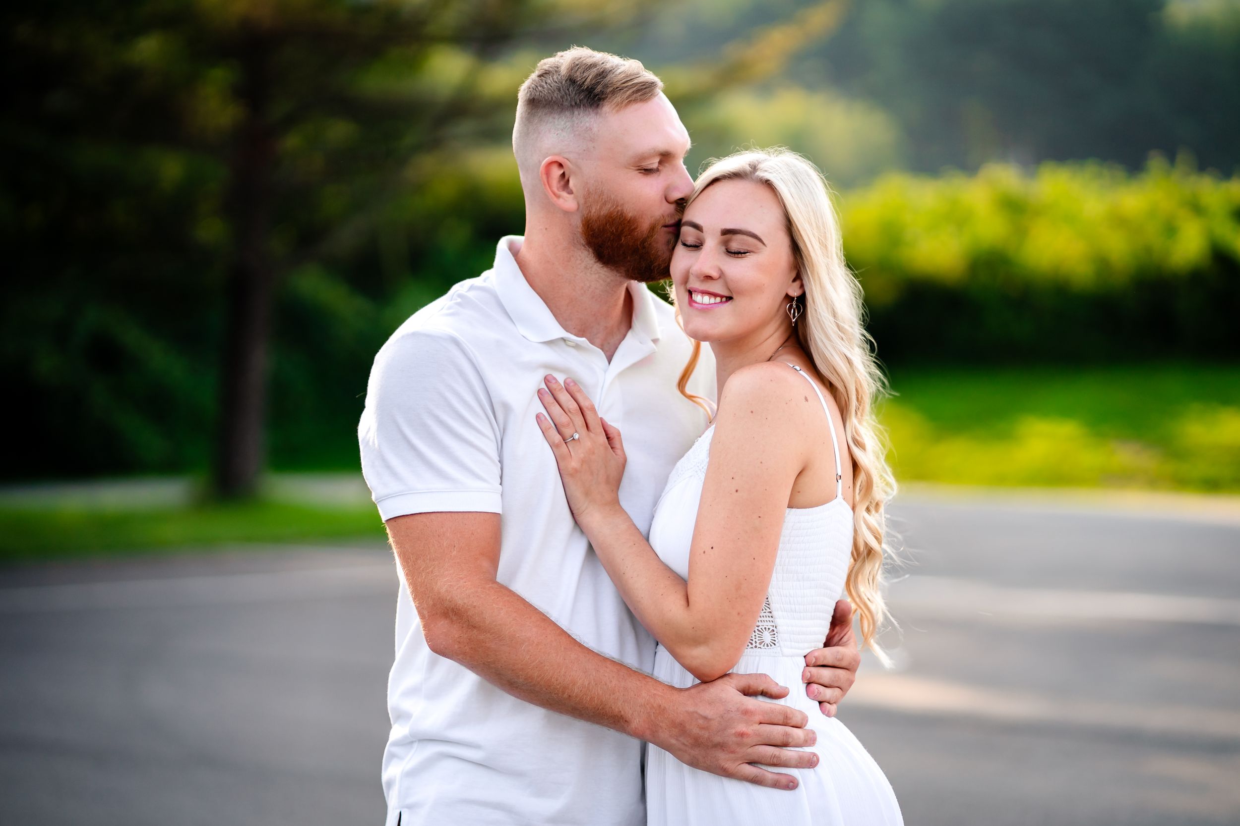 Intimate couple's portrait session showing tender moments against a natural green background.