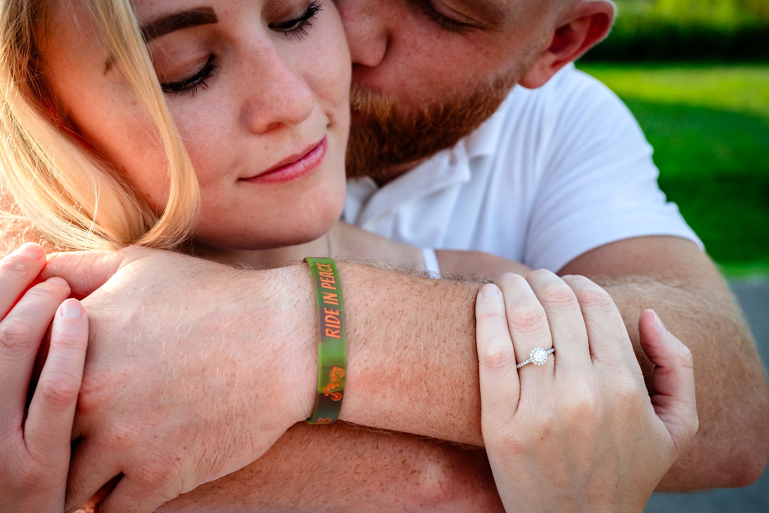 Close-up shots of couple embracing tenderly in natural outdoor lighting.