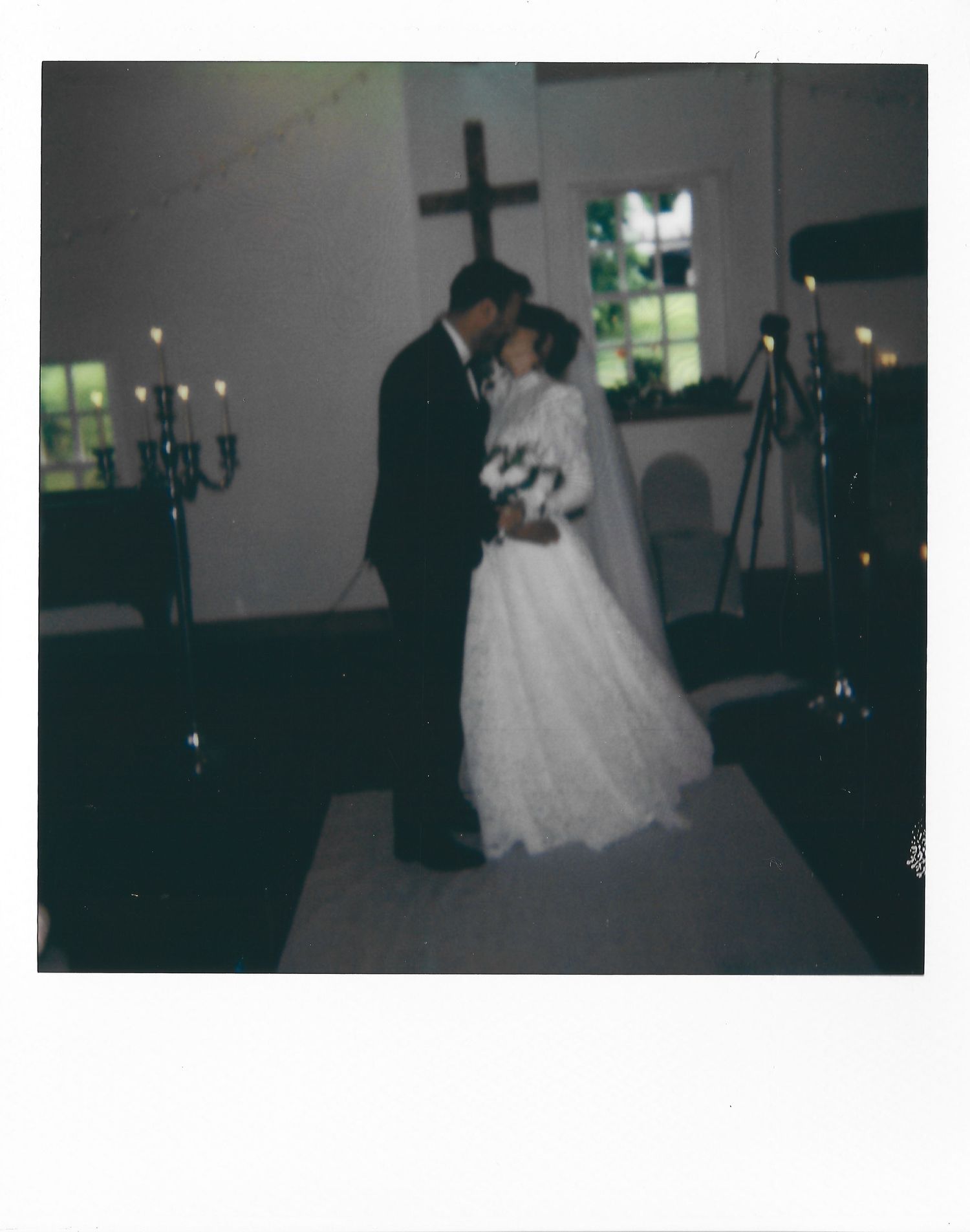 A romantic first dance between newlyweds in formal attire at an elegantly decorated wedding reception venue.