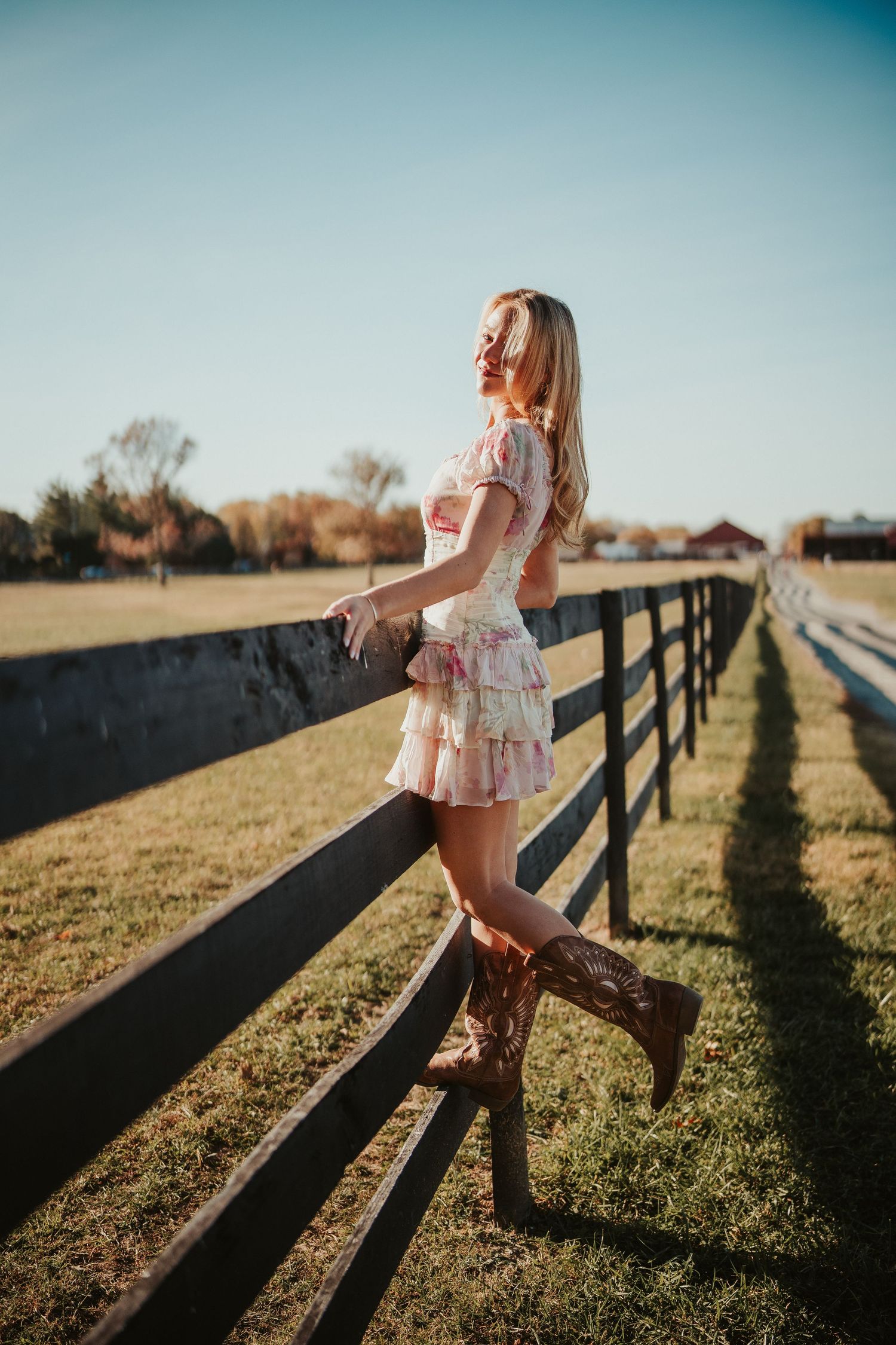 Outdoor portrait in warm sunlight with shallow depth of field and bokeh background.