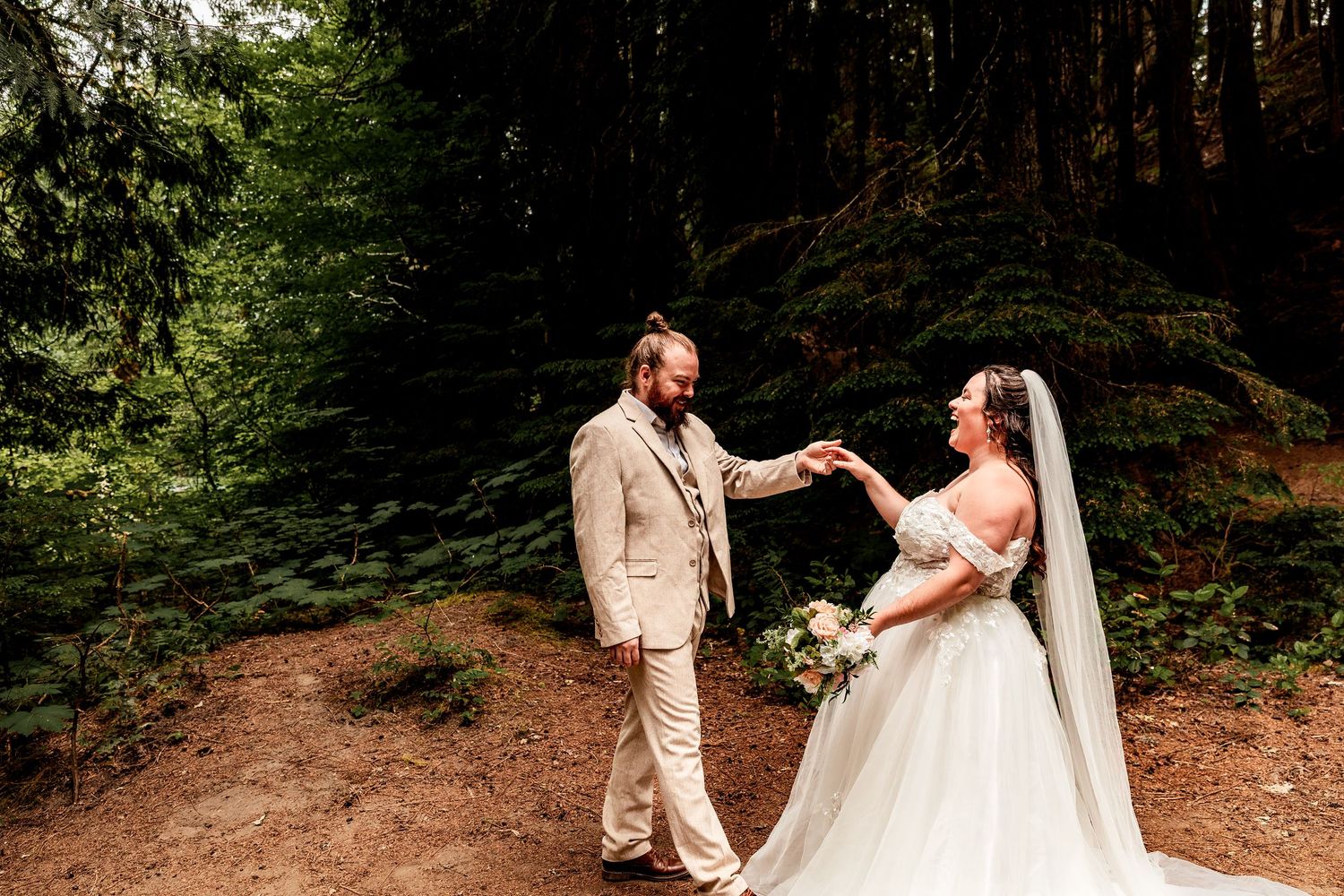 Romantic wedding photos of a couple in coordinated cream outfits posing together in a lush forest setting.
