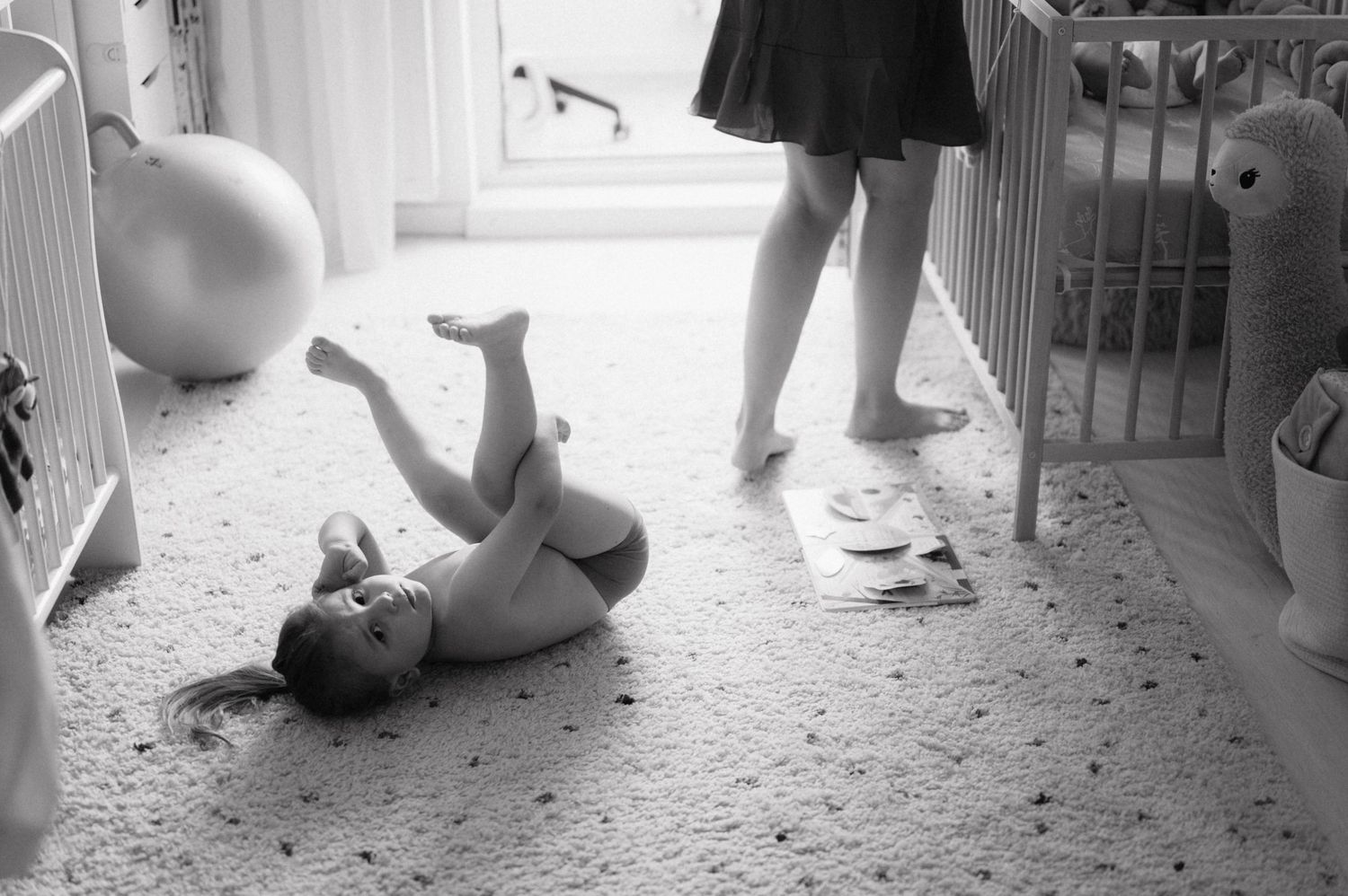 A series of black and white photographs showing ballet dancers practicing positions at a dance studio barre.